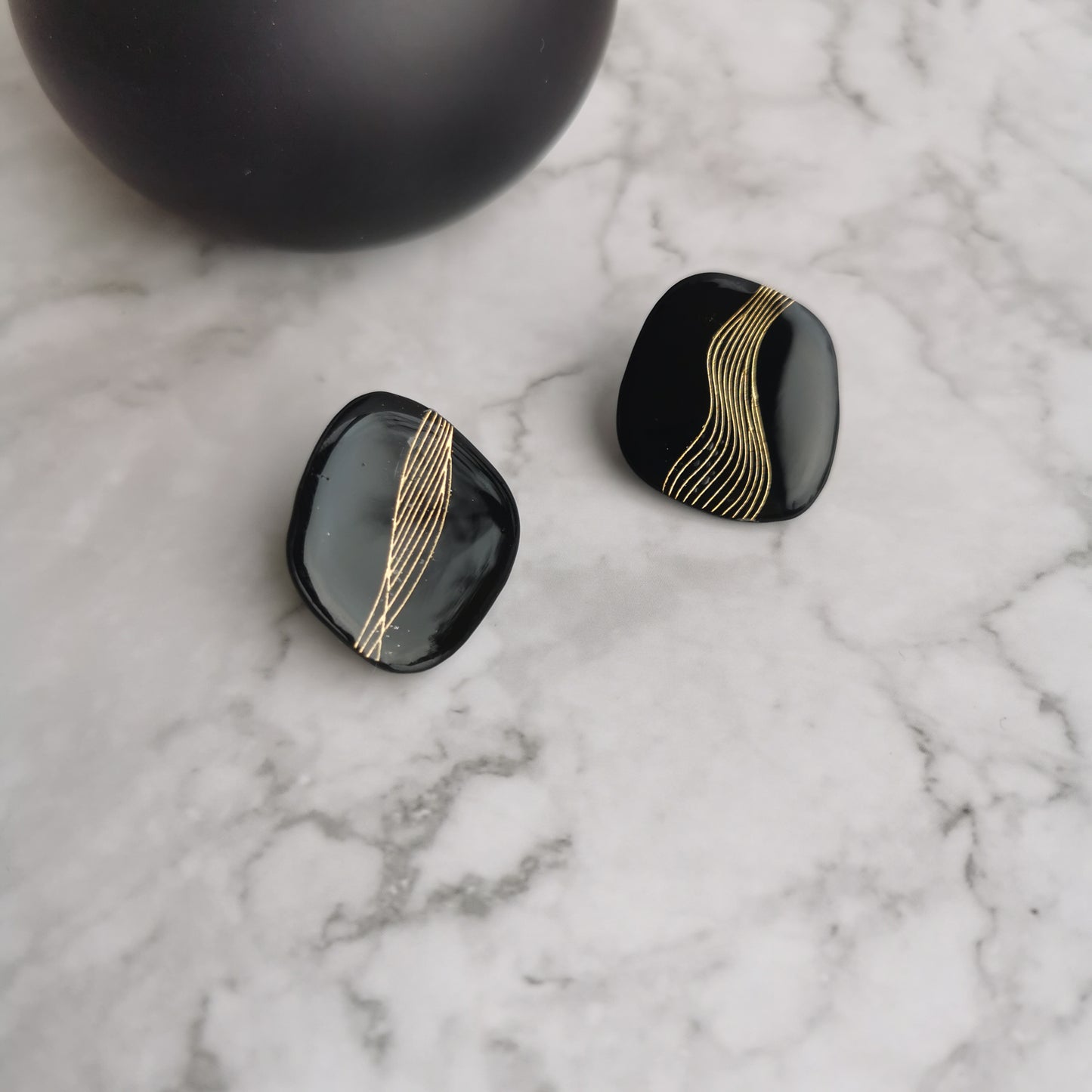 'Swirl' black and gold statement studs.